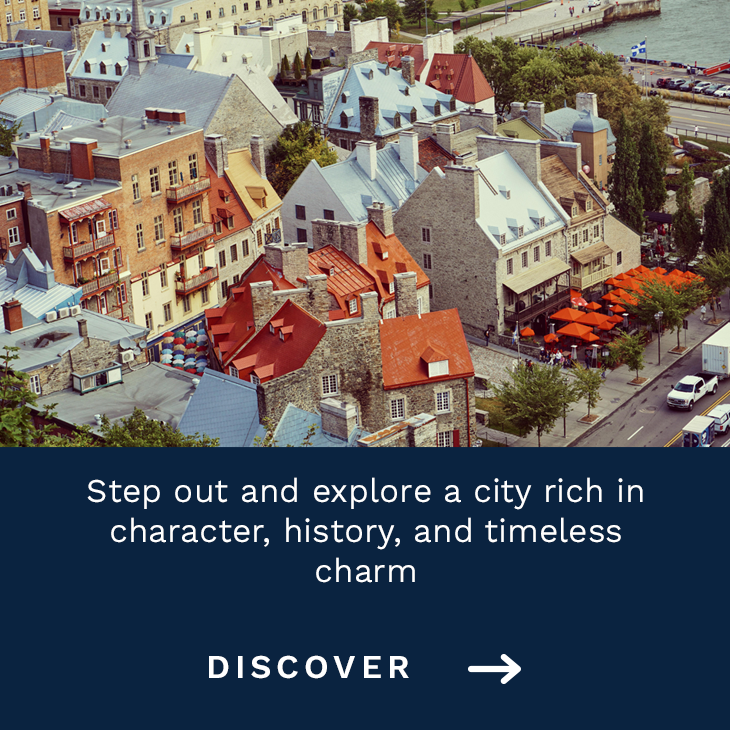 Aerial view of Old Québec featuring historic buildings, colorful rooftops, and lively streets near the St. Lawrence River.