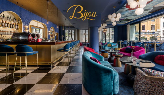 Interior of Le Bijou cocktail bar and restaurant at Hôtel Monsieur Jean featuring an elegant bar, designer seating, and a sophisticated atmosphere in Old Québec.